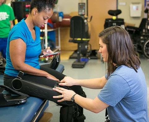 A patient is fitted for a robotic exoskeleton at Shepherd Center’s Atlanta rehabilitation facility